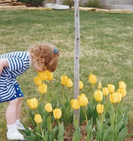 This is Kelly sniffing some flowers.